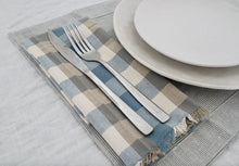Double Check Napkin S/4 Blue Haze Introducing the Raine & Humble Double Weave Napkin Where elegance meets eco-friendliness. These exquisite napkins are meticulously crafted from recycled fabric, featuring a tastefully woven check pattern in refreshing colors.