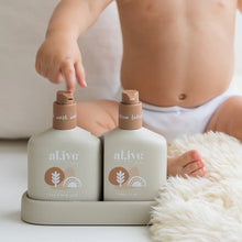 The al.ive baby Hair & Body Duo in Calming Oatmeal contains a Baby Hair & Body Wash & Body Lotion, both housed in a non-slip tray with easy-to-pump lids.