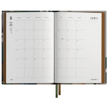 Open planner with monthly view on a white background