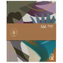 Notebook with abstract design and brown band featuring 'Ahi' branding on a white background