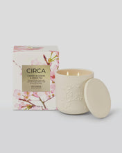 Circa cherry blossom and green tea candle with packaging on a light gray background
