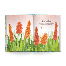 An open illustrated book spread showing watercolor-style orange flowers and green leaves on a pale pink background, with the word 'September' and small text on the right page.