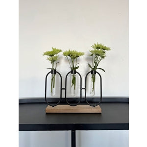 Ava Triple Bud Vase This delightful Ava triple bud vase is ideal for showing off a few stems from your garden, propagating a herb cutting, or adding green foliage to a dining table setting.Materials glass, wood and metalMeasurements: 5x7x23cm