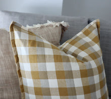 Double Check Cushion Yellow Sunset 50x50cm Upgrade your home's style and comfort with the Raine & Humble Double Weave Cushion. Thoughtfully crafted from eco-conscious recycled fabric, showcasing a tasteful woven check pattern in elegant taupe, crisp ivory, and the warm hues of Yellow Sunset.