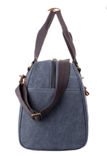Canvas duffel bag with brown straps and a visible brand logo on a white background