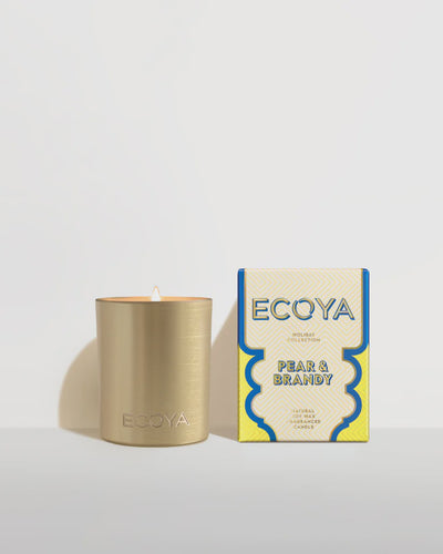 Holiday: Pear & Brandy Mini Goldie Candle By Ecoya The fragrance equivalent of a velvet-clad holiday soirée - classy with a touch of spice. Green pear, brandy, and lime with rose and jasmine, while cedar and musk add the spicy twist .