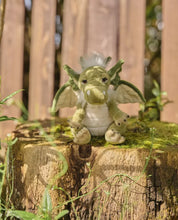 Signals Dragon Cuddle Cub by Charlie Bears Meet Signals, our captivating plush dragon designed with the youngest ones in mind. At just 13cm tall, this mythical friend is the perfect size for tiny hands to grasp and snuggle. Collectable Bears available at Rosies Gifts, Mosgiel, Dunedin.